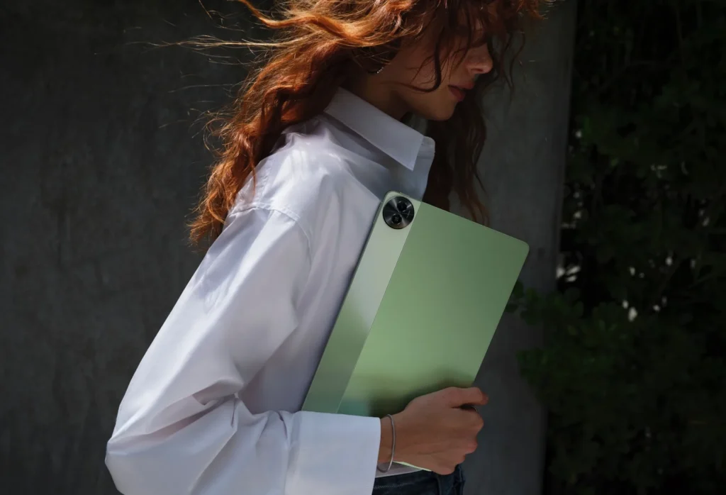 realme Pad 2, in Inspiration Green, carried by a woman