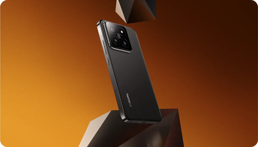 Xiaomi 14, in Black, on a block against an orange background