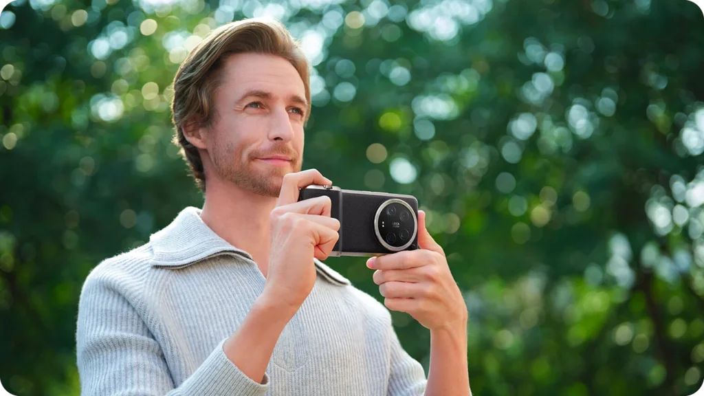 Xiaomi 14 Ultra, a man taking a photo with it outdoors
