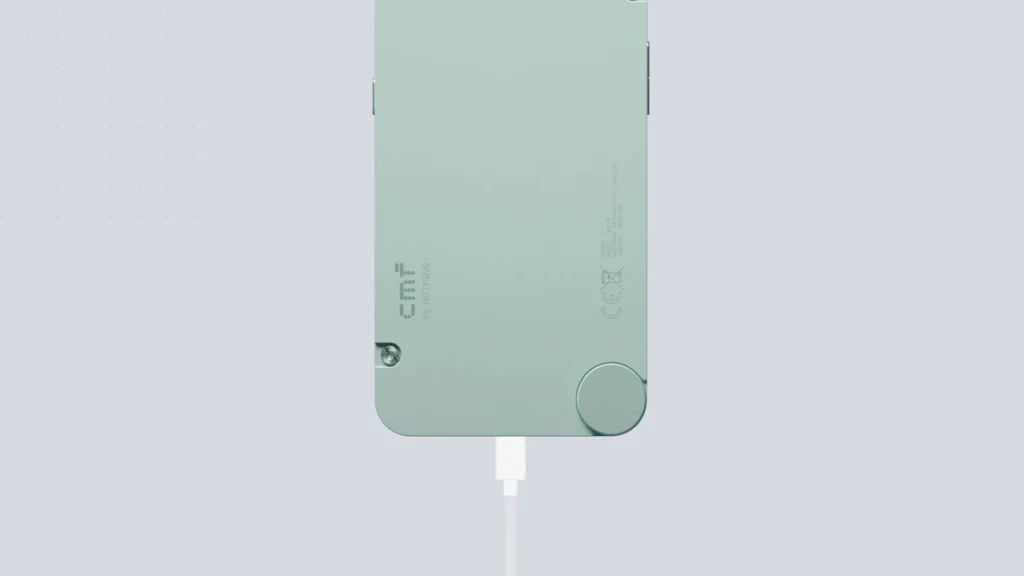Nothing CMF Phone 1, in Light Green, from the back, with a cable plugged in