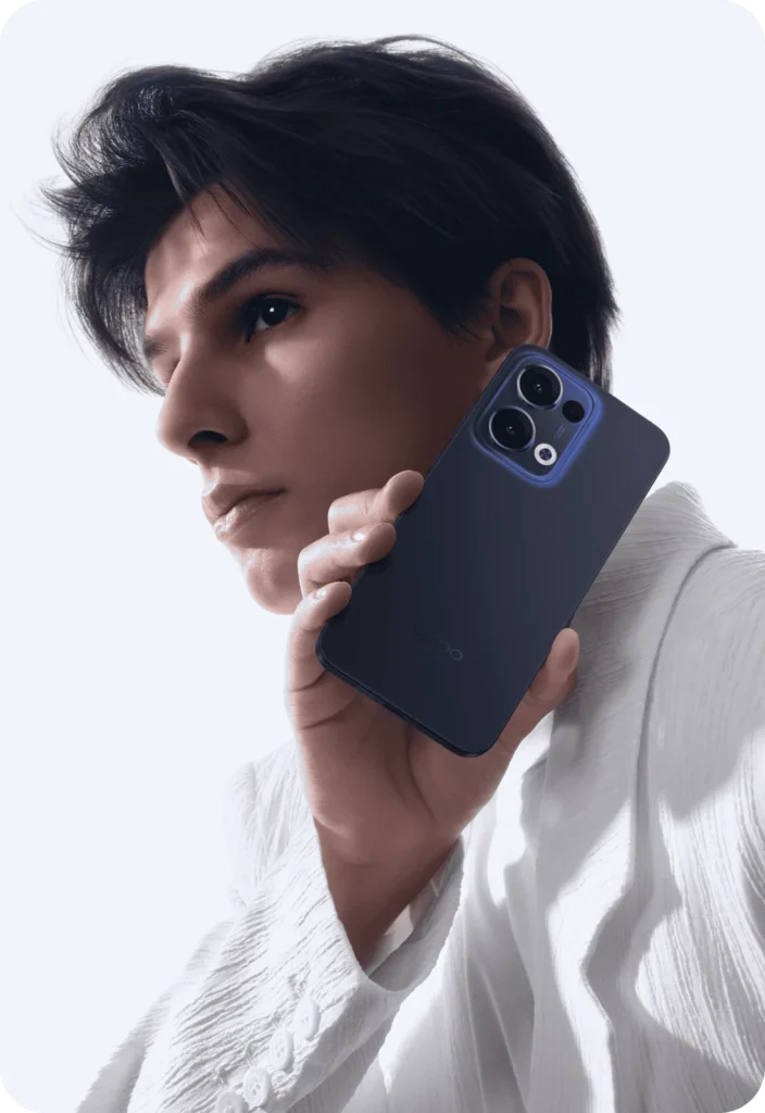 OPPO Reno13 5G, in Luminous Blue, held to the ear