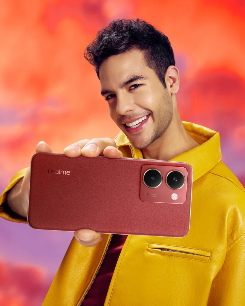 realme P3 Ultra 5G, in Orion Red, held up by a man