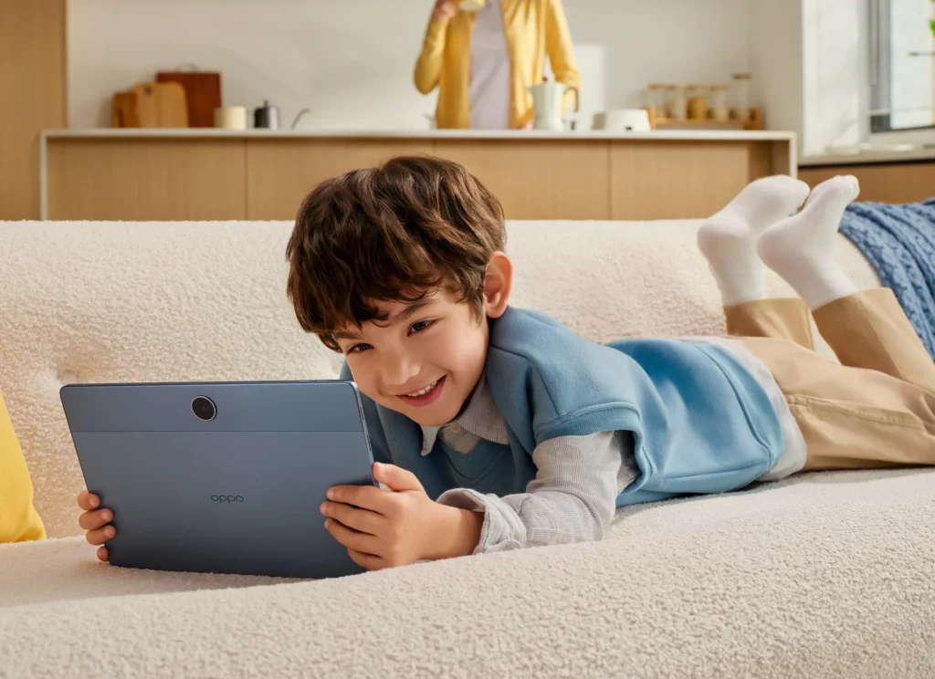 OPPO Pad SE, a boy lying on a sofa, holding it
