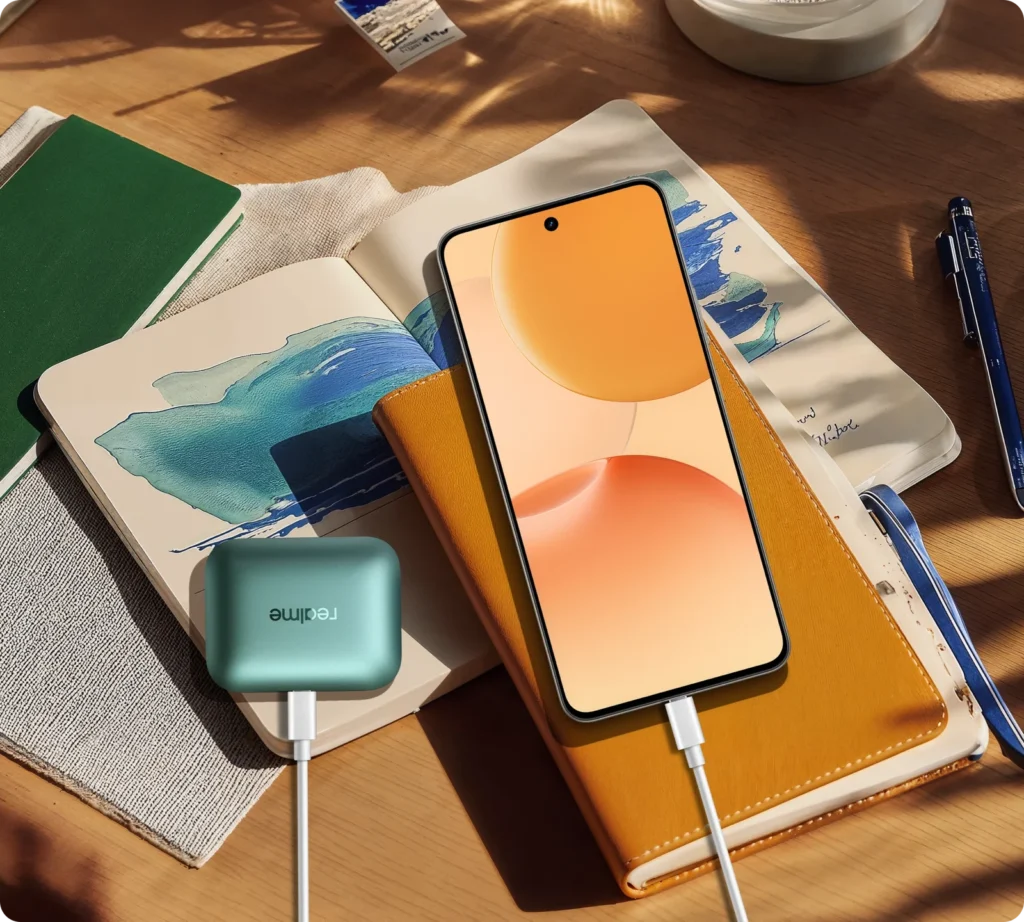 realme P4 5G, on a desk with a notebook, charging earbuds