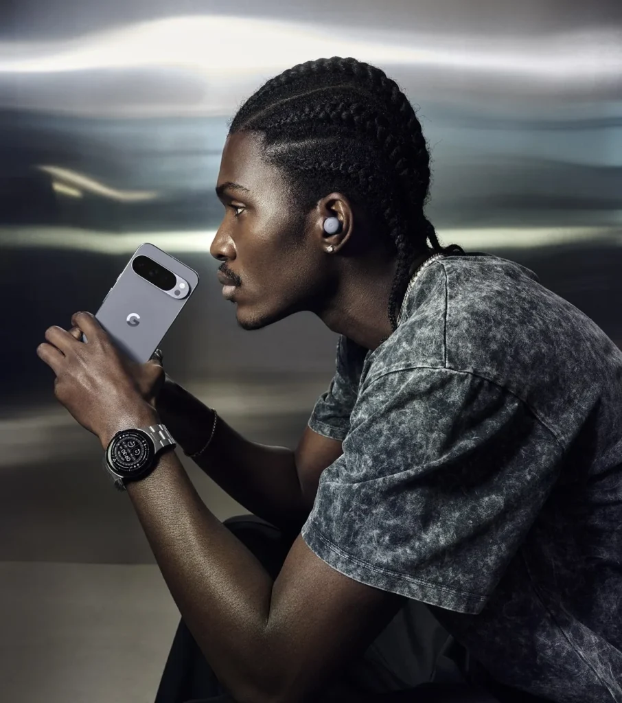 Google Pixel 10 Pro, in Moonstone, held in hands by a person in a dark t-shirt