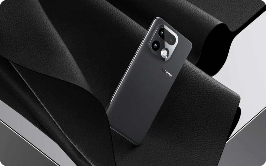 realme 16 Pro+ 5G, in Master Grey, on black fabric