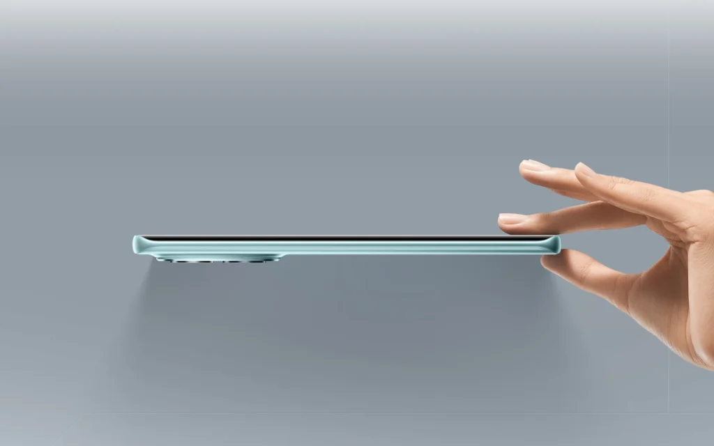 Poco M8 5G, held between finger and thumb, showing its thin side