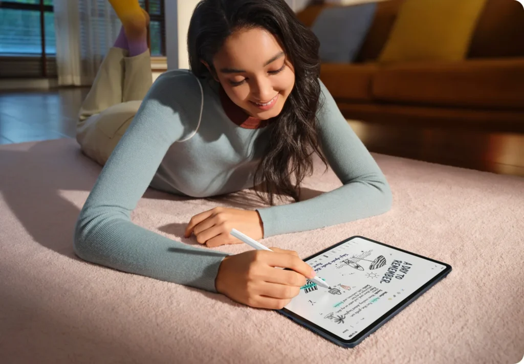 OPPO Pad 5, lying on a rug, drawing on it with the pencil