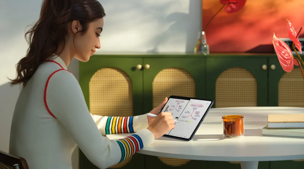 OPPO Pad 5, writing notes on it at a round table