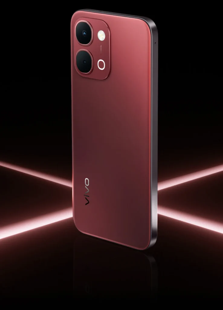 Vivo T5x 5G, in Fusion Red, standing between light beams