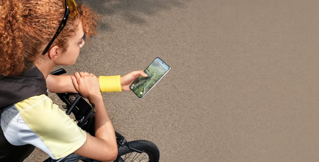 Poco X8, held in one hand on a bike ride