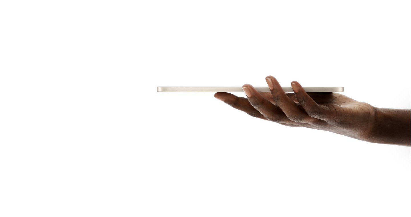 Side view of the iPad mini (A20 Pro) resting on an open hand, showing how thin the body is