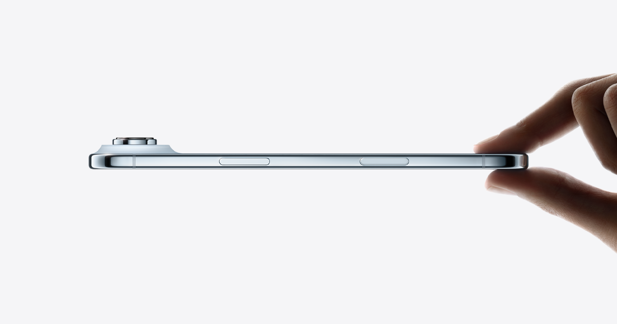Side view of a thin iPhone Air held between two fingers, showing the edge with no SIM tray