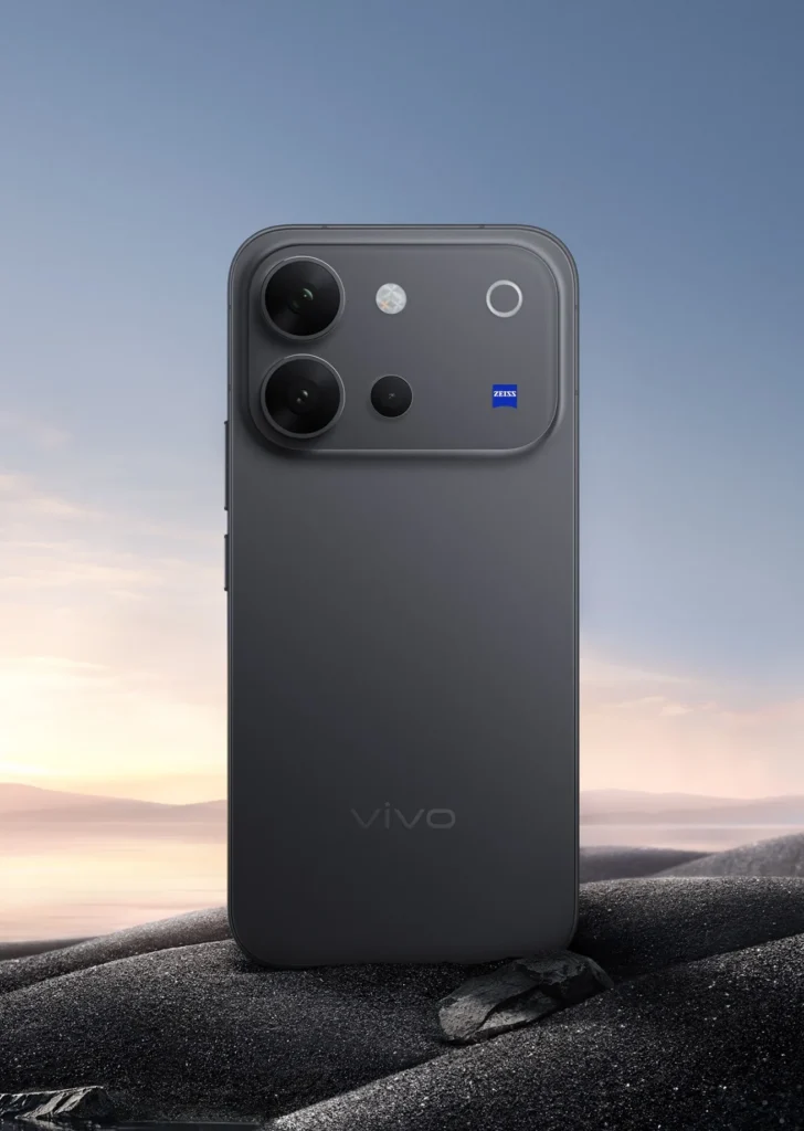 Vivo V80, in Stellar Black, standing on dark rock